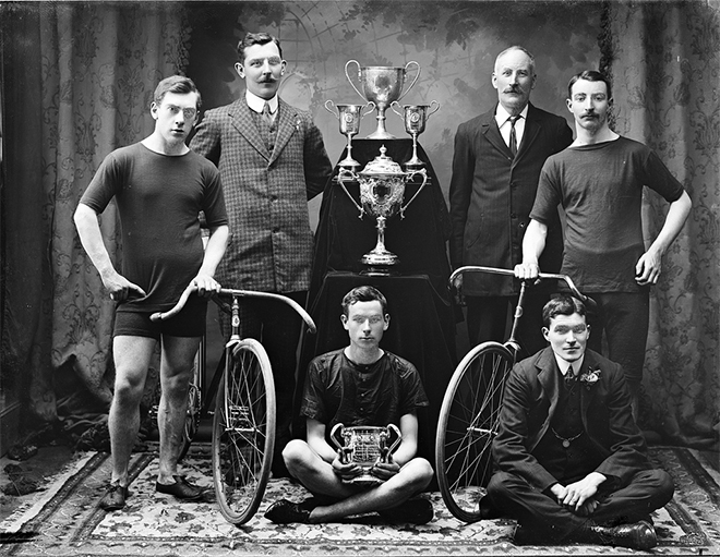 Mr Keane, City, group with bicycles & prizes. Photo by A. H. Poole Studio Photographer.